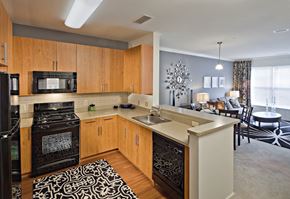 West Long Branch apartment for rent - A modern kitchen with wooden cabinets and black appliances.