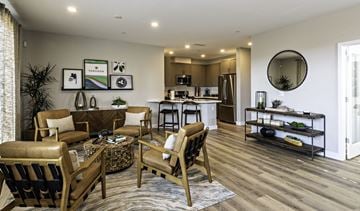 Clovis townhouse for rent - A modern living room with a brown leather chair and a wooden coffee table.