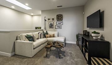 Clovis townhouse for rent - A living room with a white couch and a black TV.
