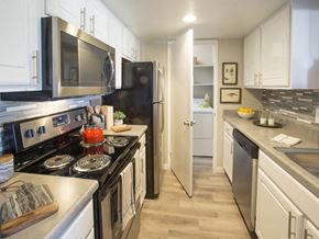 Santa Maria apartment for rent - A kitchen with black and white appliances and wooden floors.