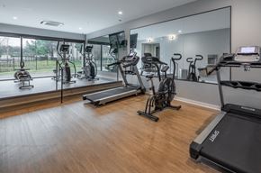 Nashville apartment for rent - a gym with treadmills and other exercise equipment on a wooden floor