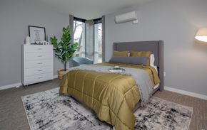Nashville apartment for rent - a bedroom with a bed and a dresser and a window