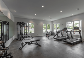 Nashville townhouse for rent - A spacious gym with treadmills, elliptical machines, and other exercise equipment.