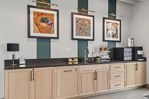 South Bend apartment for rent - A kitchen with a black counter top and wooden cabinets.
