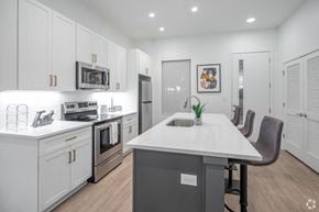 Nashville townhouse for rent - a kitchen with white cabinets and a white counter top