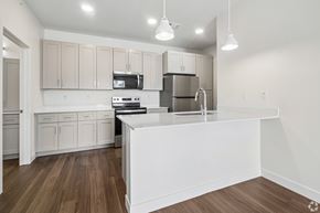 Elkhart apartment for rent - A modern kitchen with wooden floors and white appliances.