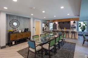 Elkhart apartment for rent - a dining area with a glass table and chairs and a bar
