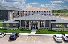 Elkhart apartment for rent - A parking lot in front of a building with a sign that says "OFFICE".