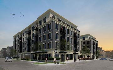 Itasca apartment for rent - A modern apartment building with a parking lot in front.