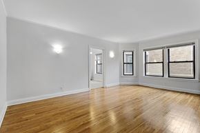 Chicago apartment for rent - A room with wooden floors and white walls.