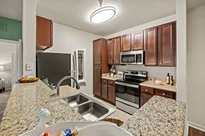 Orlando apartment for rent - a kitchen with granite counter tops and stainless steel appliances