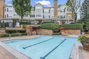 Atlanta apartment for rent - a swimming pool with an apartment building in the background