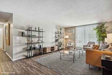 Eden Prairie apartment for rent - A living room with a grey carpet and a wooden coffee table.