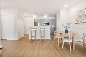 Albany apartment for rent - A kitchen with a table and chairs in the middle of the room.