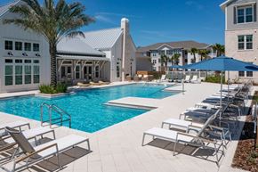 Ponte Vedra apartment for rent - a large swimming pool with lounge chairs and a building in the background
