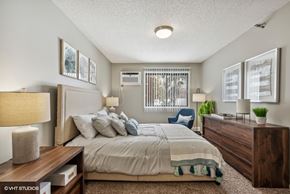 Eden Prairie apartment for rent - a bedroom with a bed and a dresser and a window