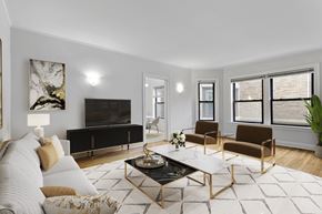 Chicago apartment for rent - A modern living room with a black sofa, a coffee table, and a painting on the wall.