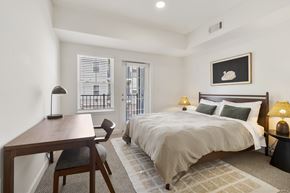 Albany apartment for rent - A bedroom with a bed, nightstand, and chair.