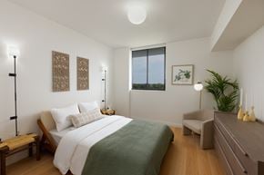 Miami apartment for rent - A bedroom with a large bed and a window overlooking the ocean.