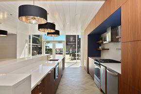 Chicago apartment for rent - a kitchen with white countertops and stainless steel appliances and a blue accent wall