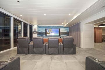 Chicago apartment for rent - A modern living room with grey sofas and a television.