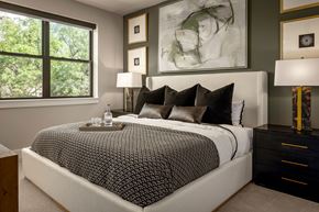 Dallas apartment for rent - A bedroom with a large bed and a painting on the wall.