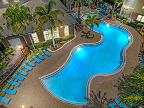 Orlando apartment for rent - a swimming pool at a resort with palm trees