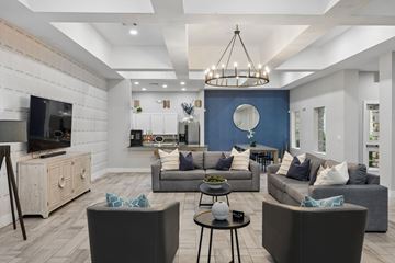 Grand Prairie apartment for rent - A modern living room with grey couches and a wooden cabinet.