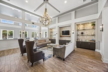 Fort Worth apartment for rent - A living room with a grey sofa and a chandelier.