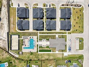 Willow Park apartment for rent - A bird's eye view of a residential area with houses, a swimming pool, and a large building.