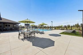 Midlothian apartment for rent - A pool area with a table and chairs and umbrellas.