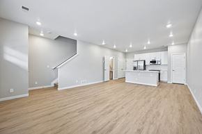 Aurora apartment for rent - A spacious room with wooden flooring and white walls.