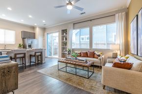 Justin apartment for rent - A living room with a couch, a coffee table, and a dining table.