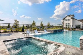 Justin apartment for rent - A pool with hot tub, and building in the background.