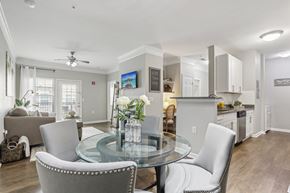 Mt Laurel apartment for rent - A modern dining room with a glass table and grey chairs.