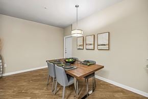 San Antonio apartment for rent - A dining room with a wooden table and grey chairs.
