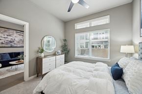 Dallas apartment for rent - A bedroom with a large bed and a ceiling fan.