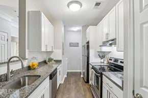 Mt Laurel apartment for rent - A kitchen with white cabinets and a granite countertop.