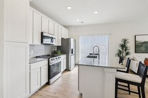 Midlothian apartment for rent - A modern kitchen with white cabinets and stainless steel appliances.