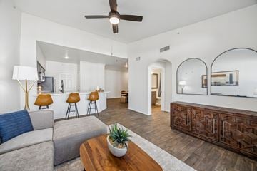 Plano apartment for rent - A living room with a grey couch and a wooden coffee table.