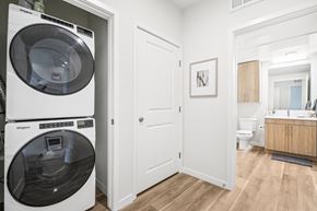 Aurora apartment for rent - A white Whirlpool washing machine is in a small laundry room.