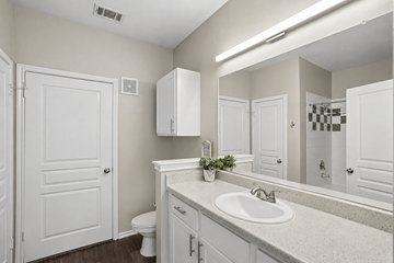 Dallas apartment for rent - A bathroom with a white sink and a white toilet.