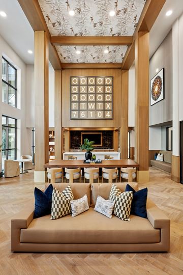 Ft Worth apartment for rent - A living room with a tan couch and a fireplace.