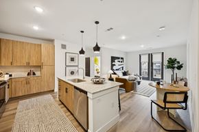 Arlington apartment for rent - A modern kitchen with wooden cabinets and a white island.
