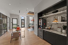 Doral apartment for rent - A modern kitchen with a marble countertop and a seating area with chairs and a table.
