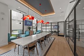 Doral apartment for rent - A modern dining area with a long table and chairs.