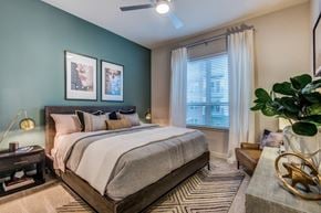Farmers Branch apartment for rent - A bedroom with a large bed and a ceiling fan.