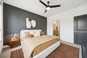 Arlington apartment for rent - A bedroom with a large bed and a ceiling fan.