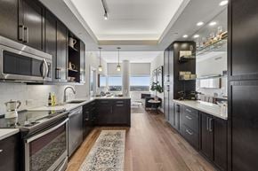 Dallas apartment for rent - A modern kitchen with dark wood cabinets and stainless steel appliances.