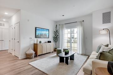 Manalapan apartment for rent - A living room with a black coffee table and a white couch.